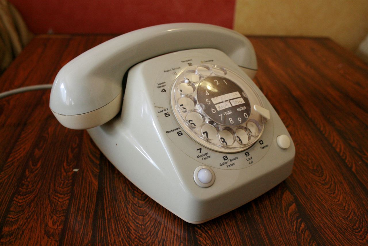 Vintage rotary telephone on a wooden table